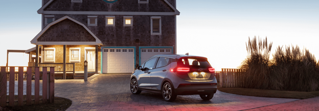 Chevy car parked in driveway at sunset